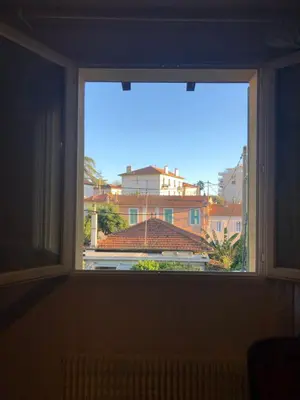 a window with a view of a building at Maison au calme avec jardin et garage proche du centre et de la mer in Cannes