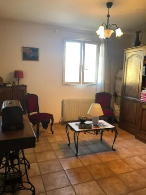 a living room with a table and chairs and a window at Maison au calme avec jardin et garage proche du centre et de la mer in Cannes