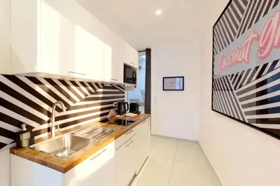 a kitchen with a sink and a sign on the wall at VILLA MARINA CANNES in Cannes