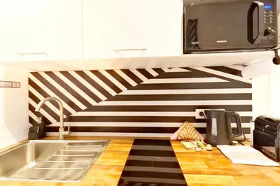 a kitchen with a black and white striped wall at VILLA MARINA CANNES in Cannes