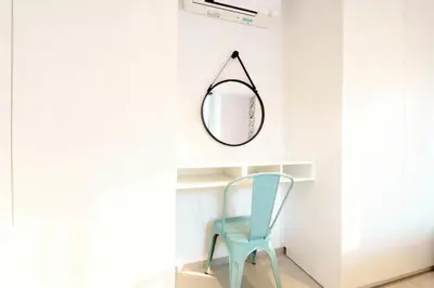a mirror and a blue chair in a room at VILLA MARINA CANNES in Cannes
