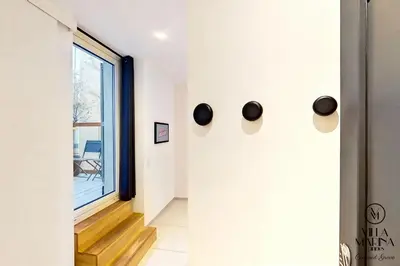 a hallway with a large window and black handles at VILLA MARINA CANNES in Cannes