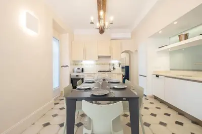 a kitchen with a black table and chairs in a room at Superb villa with swimming pool & sauna in Cannes