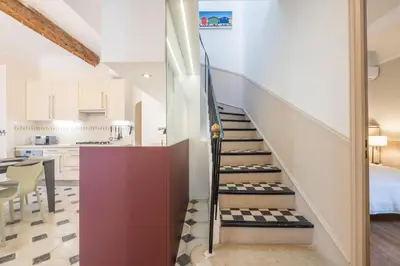 a staircase leading up to a kitchen in a house at Superb villa with swimming pool & sauna in Cannes