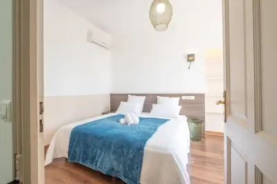 a bedroom with a bed with a blue blanket at Superb villa with swimming pool & sauna in Cannes