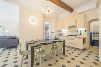 a kitchen with a dining room table and chairs at Superb villa with swimming pool & sauna in Cannes