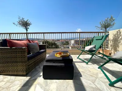 a patio with a couch and chairs on a balcony at RoofTop Apartement - Quartier Croisette - Esc'Appart in Cannes
