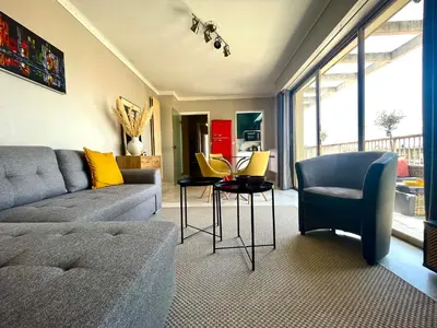 a living room with a couch and a table and chairs at RoofTop Apartement - Quartier Croisette - Esc'Appart in Cannes