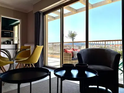 a living room with chairs and tables and a balcony at RoofTop Apartement - Quartier Croisette - Esc'Appart in Cannes