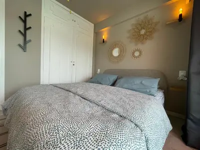 a bedroom with a bed and a cross on the wall at RoofTop Apartement - Quartier Croisette - Esc'Appart in Cannes