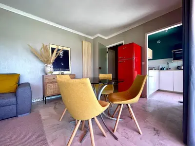 a kitchen with a table and chairs and a red refrigerator at RoofTop Apartement - Quartier Croisette - Esc'Appart in Cannes