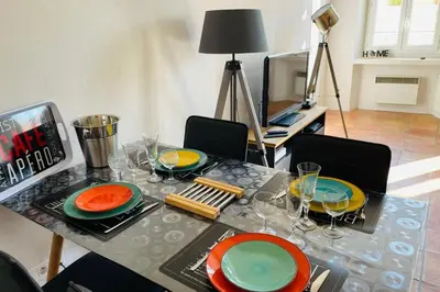 a living room with a blue couch and a door at Old city - very charming 1-bedroom apt in Cannes