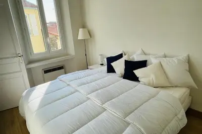 a living room with a couch and a tv at Old city - very charming 1-bedroom apt in Cannes