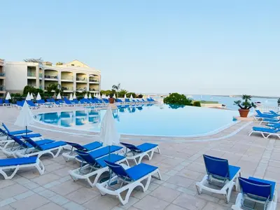 a group of chairs and a swimming pool at a resort at Villa Francia, Cannes,minimum 5 nuits de sejour in Cannes