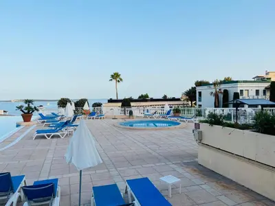 a patio with blue chairs and a swimming pool at Villa Francia, Cannes,minimum 5 nuits de sejour in Cannes