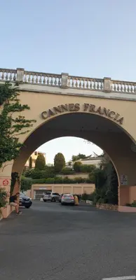 a bridge over a road with cars parked under it at Villa Francia, Cannes,minimum 5 nuits de sejour in Cannes