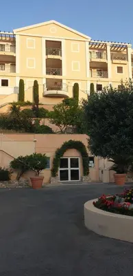 a large yellow building with flowers in front of it at Villa Francia, Cannes,minimum 5 nuits de sejour in Cannes