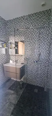 a bathroom with a shower and a sink and a mirror at SUPERBE MAISON 6 ch, 4 sdb, terrasses et billard in Cannes