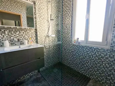 a bathroom with a sink and a shower and a mirror at SUPERBE MAISON 6 ch, 4 sdb, terrasses et billard in Cannes