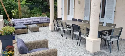 a patio with a table and chairs and a couch at SUPERBE MAISON 6 ch, 4 sdb, terrasses et billard in Cannes