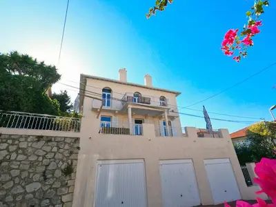 a house with white doors and a stone wall at SUPERBE MAISON 6 ch, 4 sdb, terrasses et billard in Cannes