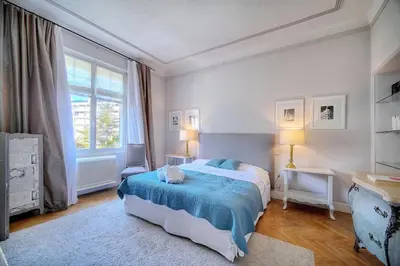a bedroom with a bed and a large window at Cannes Luxury Rental - Belle epoque villa to rent close to Cannes center in Cannes