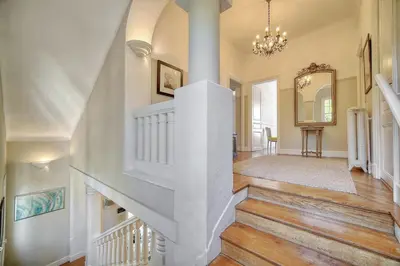 a white staircase in a home with a mirror at Cannes Luxury Rental - Belle epoque villa to rent close to Cannes center in Cannes