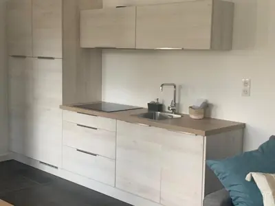 a kitchen with white cabinets and a sink at CANNES - PETIT JUAS, CHARMANTE VILLA AU CALME, TOUT CONFORT in Cannes