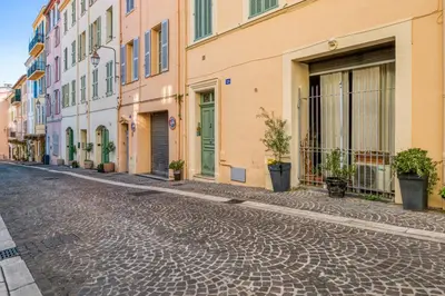 a cobblestone street in a city with buildings at Appartement Perrissol - Welkeys in Cannes