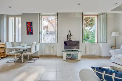 a living room with a couch and a table at Appartement Perrissol - Welkeys in Cannes