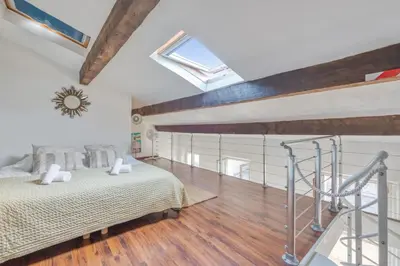 a bedroom with a bed and a skylight at Appartement Perrissol - Welkeys in Cannes