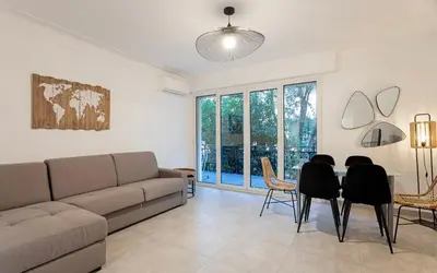 a living room with a couch and chairs and a table at Appart 2 pièces Cannes Croisette-Martinez in Cannes