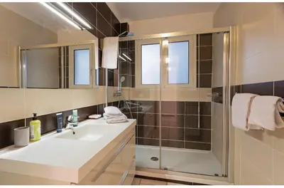 a bathroom with a sink and a shower at Appart 2 pièces Cannes Croisette-Martinez in Cannes