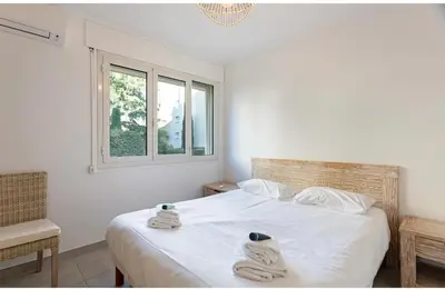 a bedroom with a white bed with towels on it at Appart 2 pièces Cannes Croisette-Martinez in Cannes