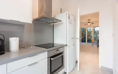 a kitchen with a stove and a refrigerator at Appart 2 pièces Cannes Croisette-Martinez in Cannes