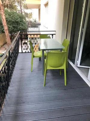 a green table and chairs on a balcony at Appart 2 pièces Cannes Croisette-Martinez in Cannes
