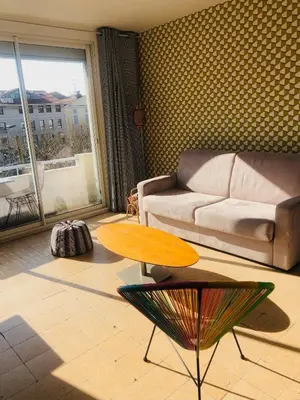 a living room with a couch and a table at Croisette Beach Cannes Banane 4 sleeps Apart in Cannes
