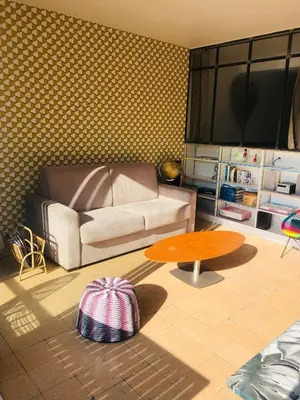 a living room with a couch and a table at Croisette Beach Cannes Banane 4 sleeps Apart in Cannes