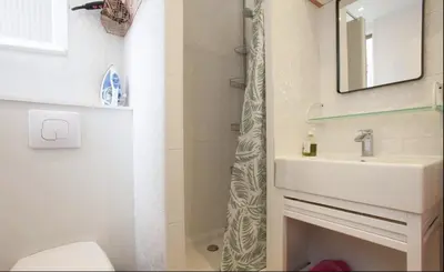 a bathroom with a sink and a toilet and a shower at Croisette Beach Cannes Banane 4 sleeps Apart in Cannes