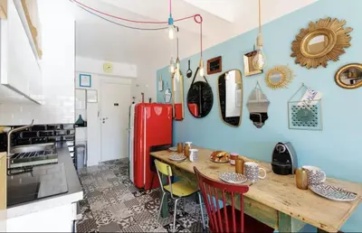 a kitchen with a wooden table and a red refrigerator at Croisette Beach Cannes Banane 4 sleeps Apart in Cannes