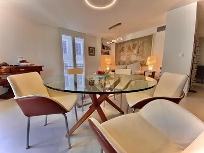 a dining room with a glass table and chairs at Grand Palais ANT1308 in Cannes