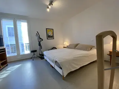 a bedroom with a bed and a large window at Grand Palais ANT1308 in Cannes