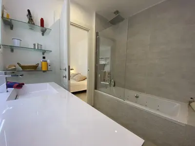 a white bathroom with a tub and a sink at Grand Palais ANT1308 in Cannes