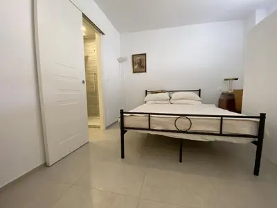a bedroom with a bed in a white room at Grand Palais ANT1308 in Cannes