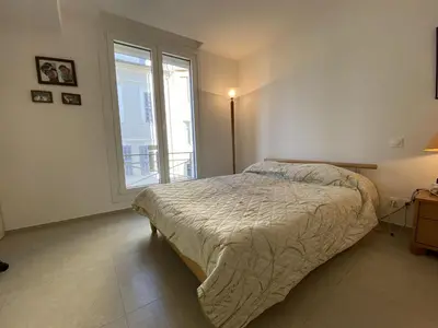 a bedroom with a bed and a large window at Grand Palais ANT1308 in Cannes