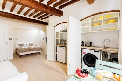 a kitchen and living room with a washer and dryer at Panisse YourHostHelper in Cannes