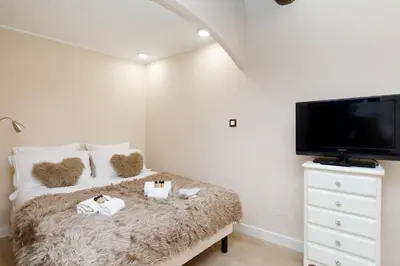 a bedroom with a bed and a flat screen tv at Panisse YourHostHelper in Cannes