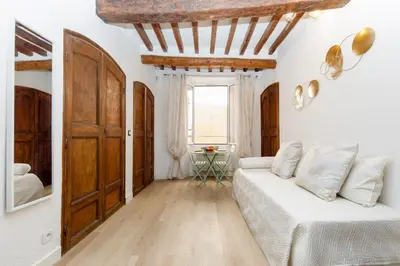 a white room with a bed and a window at Panisse YourHostHelper in Cannes