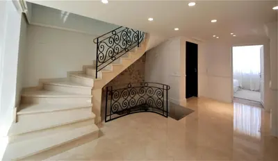 a staircase in a house with a wrought iron railing at FOCH Bright prestigious apartment in Cannes ! in Cannes