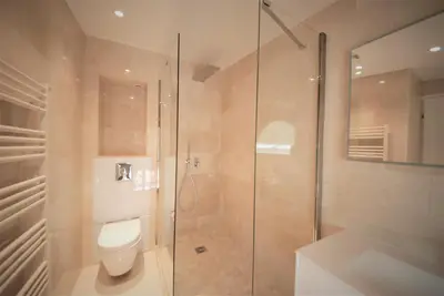 a bathroom with a toilet and a glass shower at FOCH Bright prestigious apartment in Cannes ! in Cannes